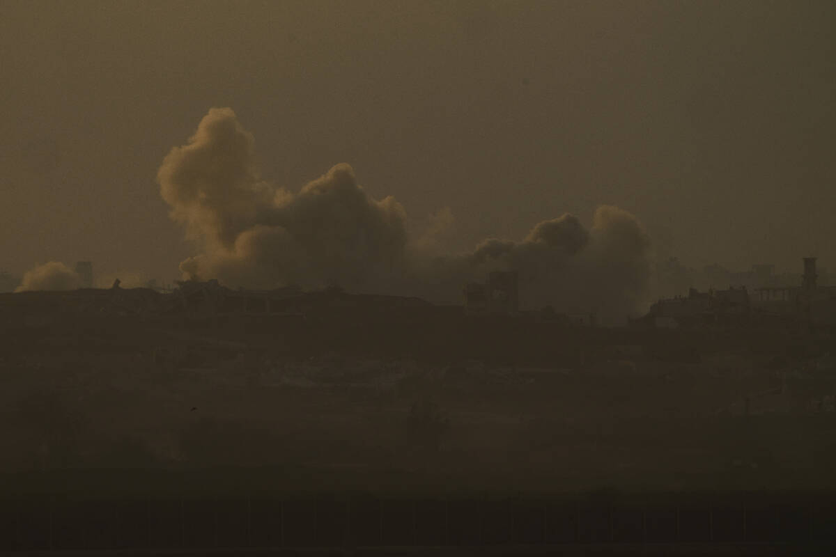 Smoke from Israeli bombardment billows over the Gaza Strip, seen from southern Israel, Wednesda ...