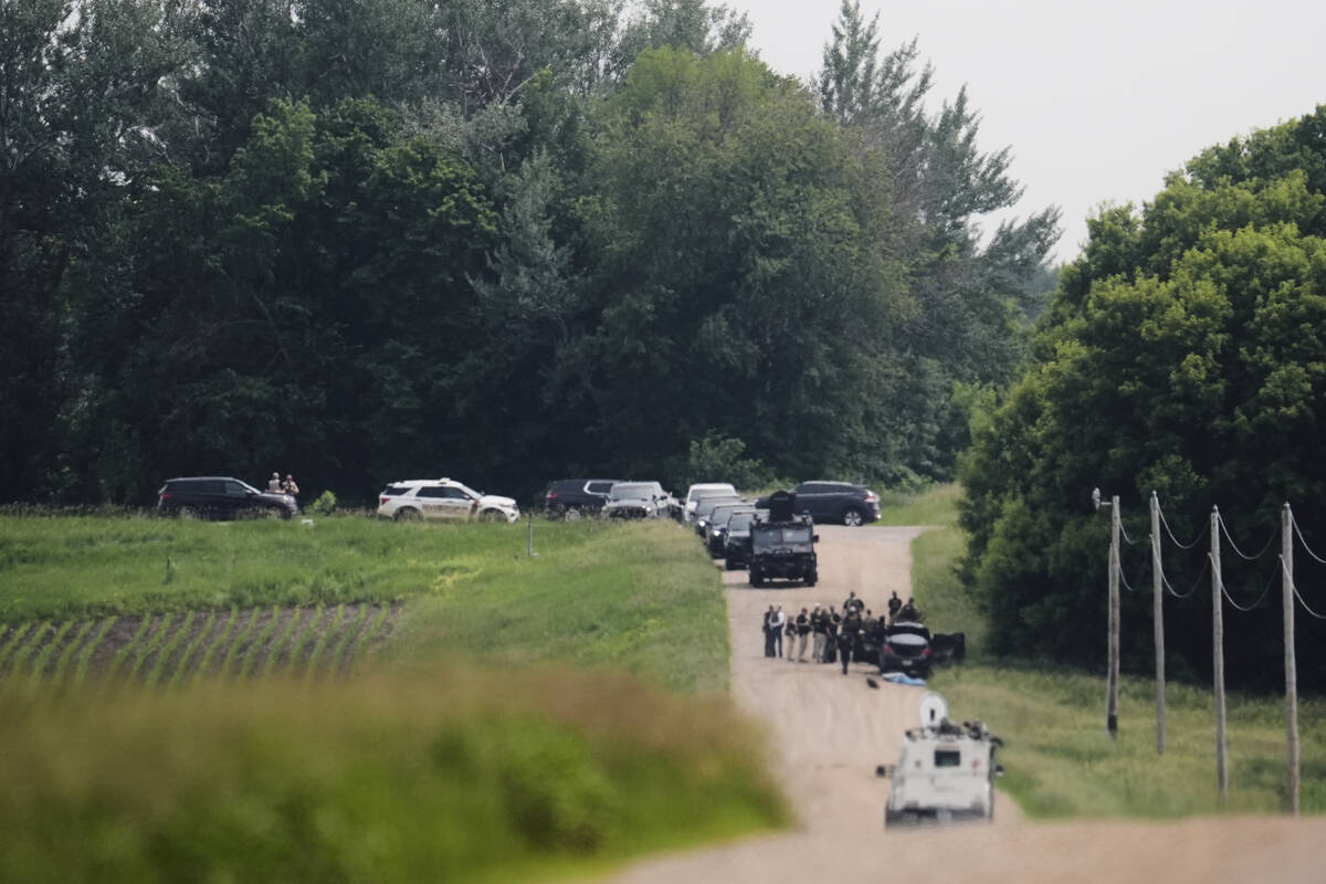 Members of law enforcement agencies investigate near a vehicle suspected to belong to shooting ...